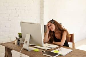 a woman sitting at a desk with a computer