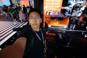A man standing in front of a display of cars