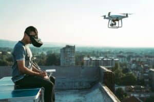 Man with drone flying at the city