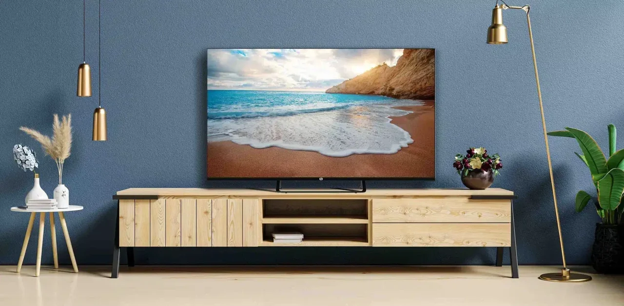 Un téléviseur posé sur un meuble TV dans un salon lumineux.