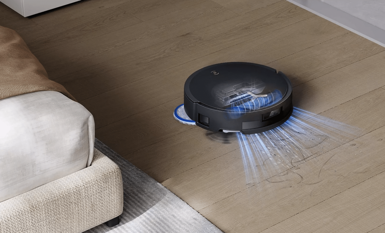 Un aspirateur robot de la marque Ecovacs sur un parquet.