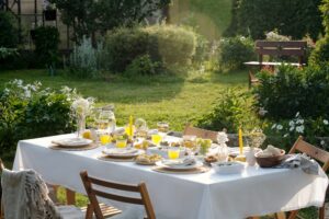 Sunlit Outdoor Garden Table Arranged for Relaxing Summer Brunch Gathering