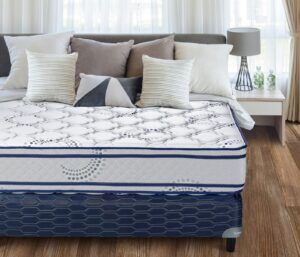 A neatly made bed with a patterned mattress and pillows.