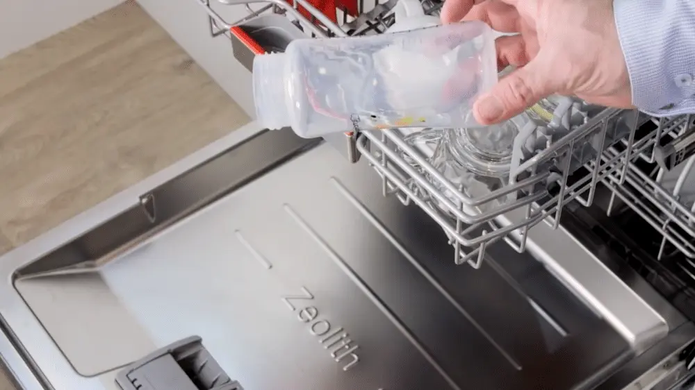 Une personne retirant une bouteille en plastique parfaitement sèche d'un lave-vaisselle Bosch équipé de la technologie PerfectDry.